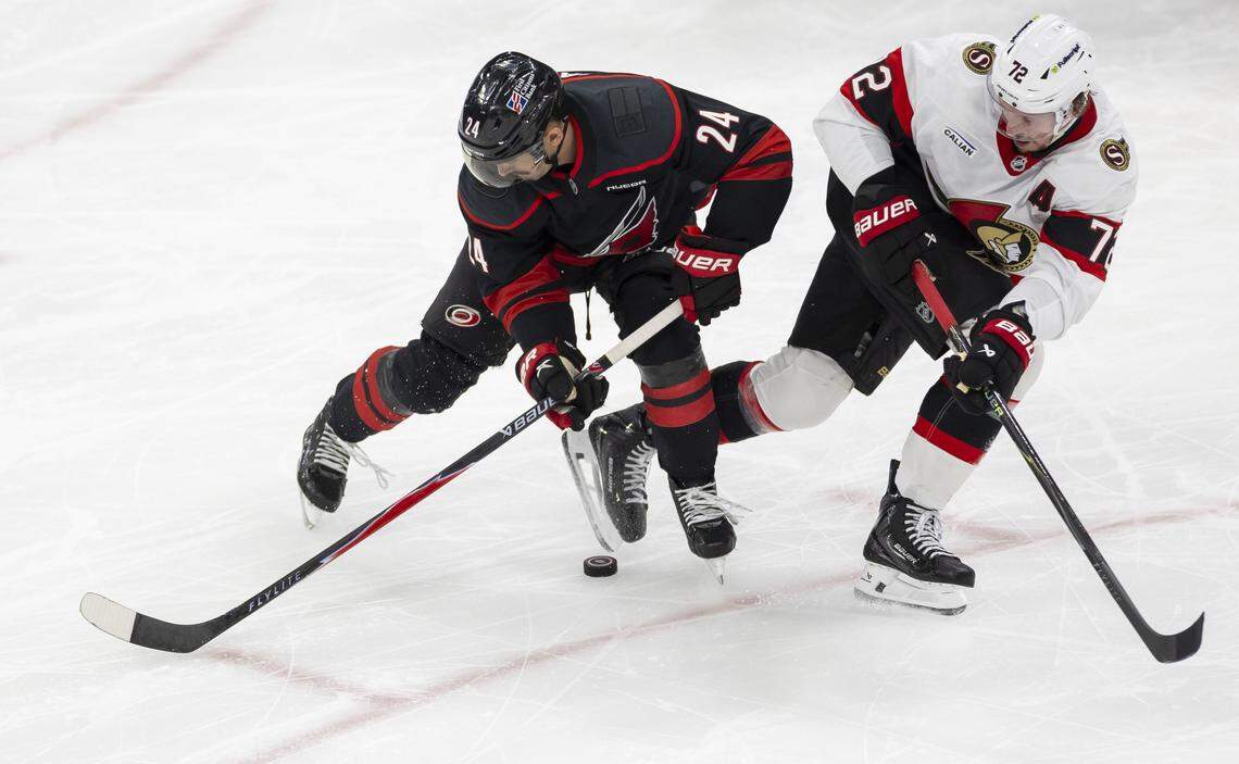 Carolina Hurricanes center Seth Jarvis (24) battles with Ottawa defenseman Thomas Chabot (72) for control of the puck in the second period on Saturday, April 18, 2026, during the first round of the Stanley Cup playoffs at Lenovo Center in Raleigh, North Carolina. 