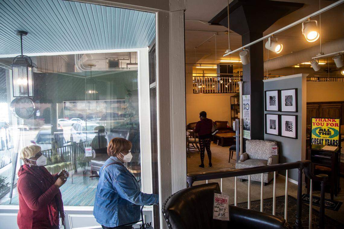 Customers shop at Whitley Furniture Gallery in downtown Zebulon Tuesday, Jan. 25, 2022. The store is going out of business after four generations of family operation and the city block it covers will likely be redeveloped.