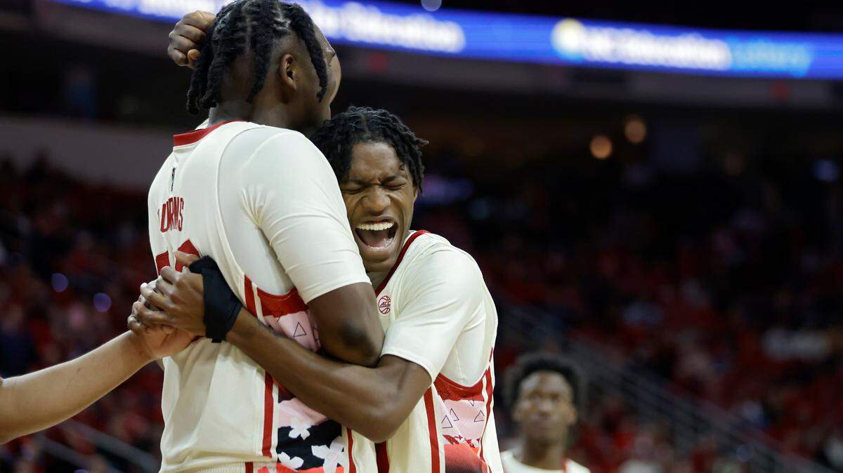 North Carolina State’s D.J. Burns Jr. and Terquavion Smith embrace following a Georgia Tech foul during the second half of the Wolfpack’s 72-64 win at PNC Arena on Saturday, Feb. 4, 2023, in Raleigh, N.C.