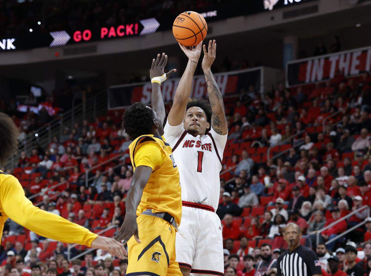 N.C. State’s Darrion Williams shoots over UNC Greensboro’s Assane Mandian during the first half of the Wolfpack’s 110-64 win on Wednesday, Nov. 12, 2025, at Lenovo Center in Raleigh, N.C.