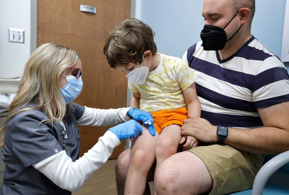 Callan Sanchez, 4, of Chapel Hill looks at where he just received a Moderna COVID-19 vaccine from Lynell Batchelor, RN, at UNC Family Medicine & Pediatrics at Panther Creek in Cary, N.C., on Friday, June 24, 2022. With Callan is his father Jaime Sanchez. The vaccine was just authorized for children from six months to five years old. Callan said the shot “wasn’t a bad one.”