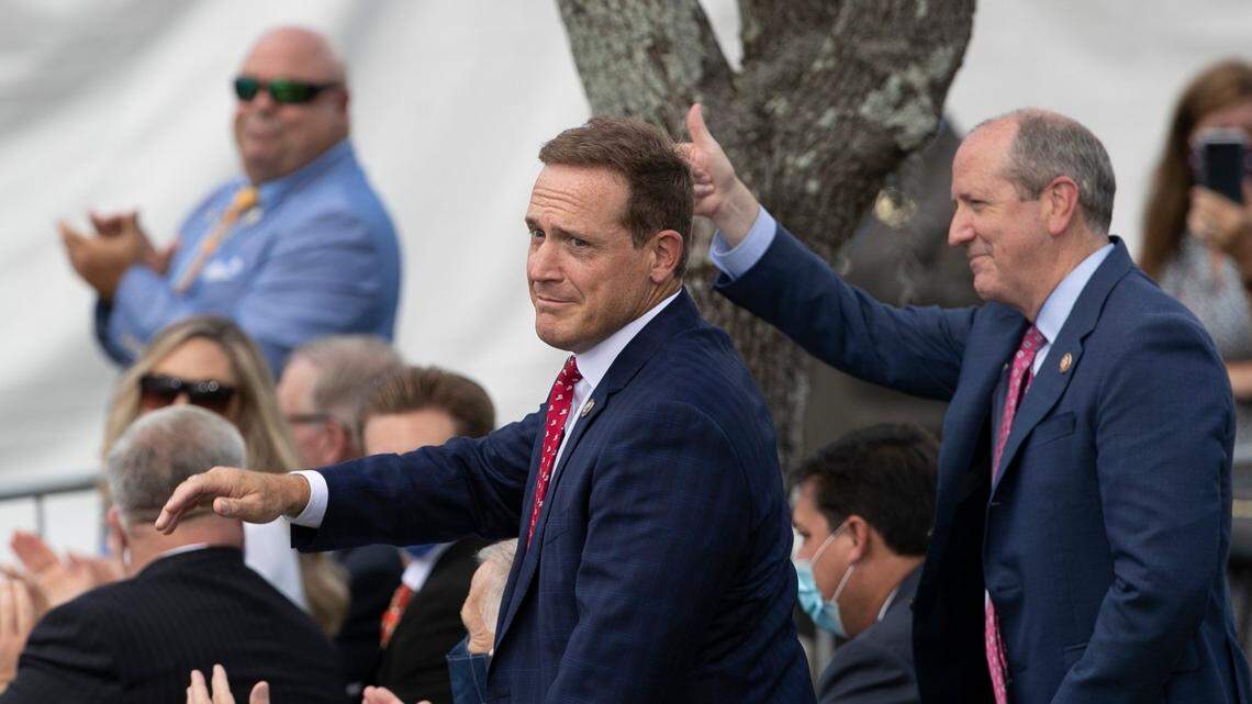 Rep. Ted Budd, left, and Rep. Dan Bishop are recognized by President Donald Trump during a September visit to Wilmington, N.C. Bishop and Budd are now among 100 GOP members of Congress formally backing a Texas lawsuit seeking to overturn the results of the 2020 presidential election.