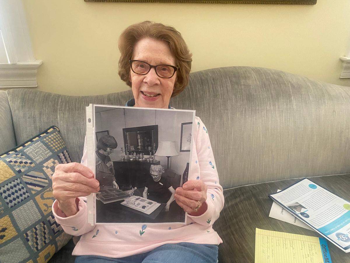 Juliette Singleton holds a photograph that documented Raleigh’s first-ever Meals on Wheels delivery 50 years ago in 1974, when she served Ellen Dortch Shore.