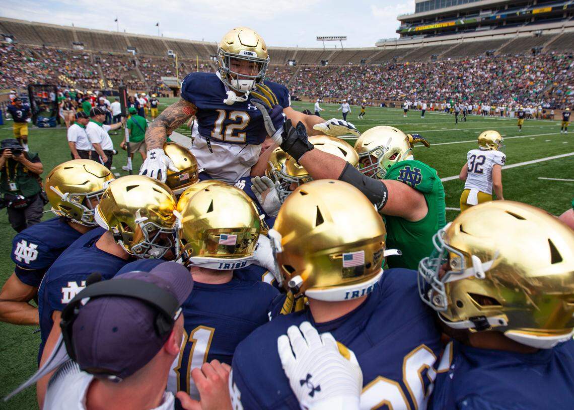 Players celebrate scoring during the Notre Dame Blue-Gold Spring NCAA college football game on Saturday, April 23, 2022, at Notre Dame Stadium in South Bend, Ind. (Michael Caterina/South Bend Tribune via AP)