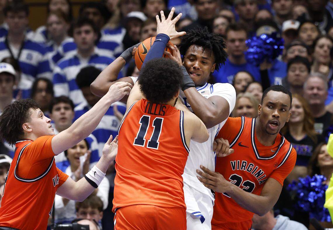 Duke’s Patrick Ngongba II (21) pulls in the rebound from Virginia's Devin Tillis (11), Chance Mallory (2) and Ugonna Onyenso (33) during the second half of  Duke’s 77-51 victory over Virginia at Cameron Indoor Stadium in Durham, N.C., Saturday, Feb. 28, 2026.