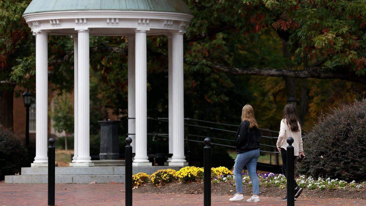 People walk through the campus of UNC-Chapel Hill on Monday, Oct. 31, 2022, in Chapel Hill, N.C.