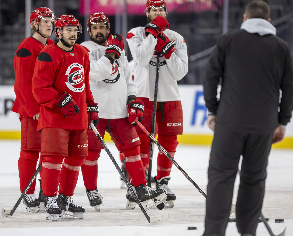 Carolina Hurricanes center Logan Stankoven (22) and teammates listen to goaltending coach Paul Schonfelder during practice on Monday, June 8, 2026 at T-Mobile Arena in Las Vegas, NV