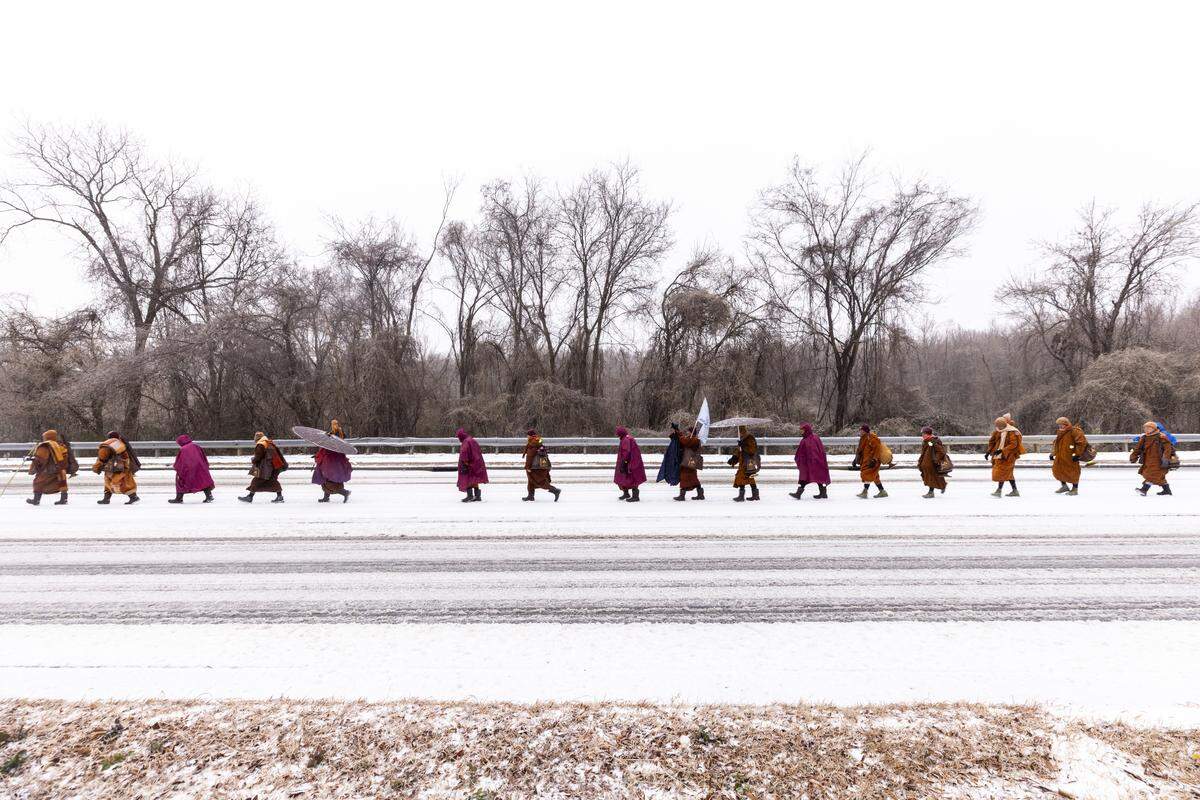 A procession of Buddhist monks walks along snow-covered Raleigh Boulevard in Raleigh on Sunday morning, Jan. 25, 2026. The monks are making a 2,300-mile pilgrimage from Texas to Washington, D.C., as part of the Walk for Peace, an effort to promote peace, compassion and national unity.