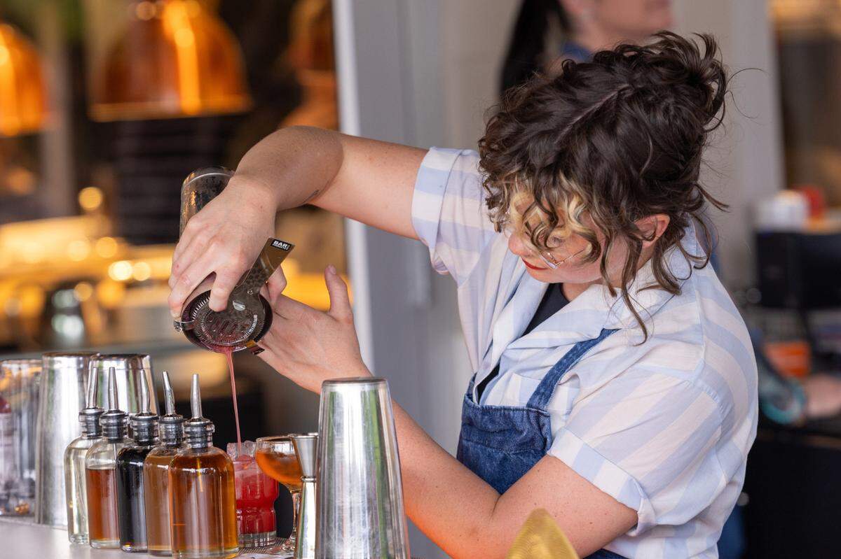 Maile Mc Naughton mixes drinks during a soft opening Thursday June 15, 2023 at Ajja, a new restaurant from Cheetie Kumar and Paul Siler in on Bickett Blvd. in Raleigh. Ajja focuses on Mediterranean, Middle Eastern and Southwest Asian flavors.
