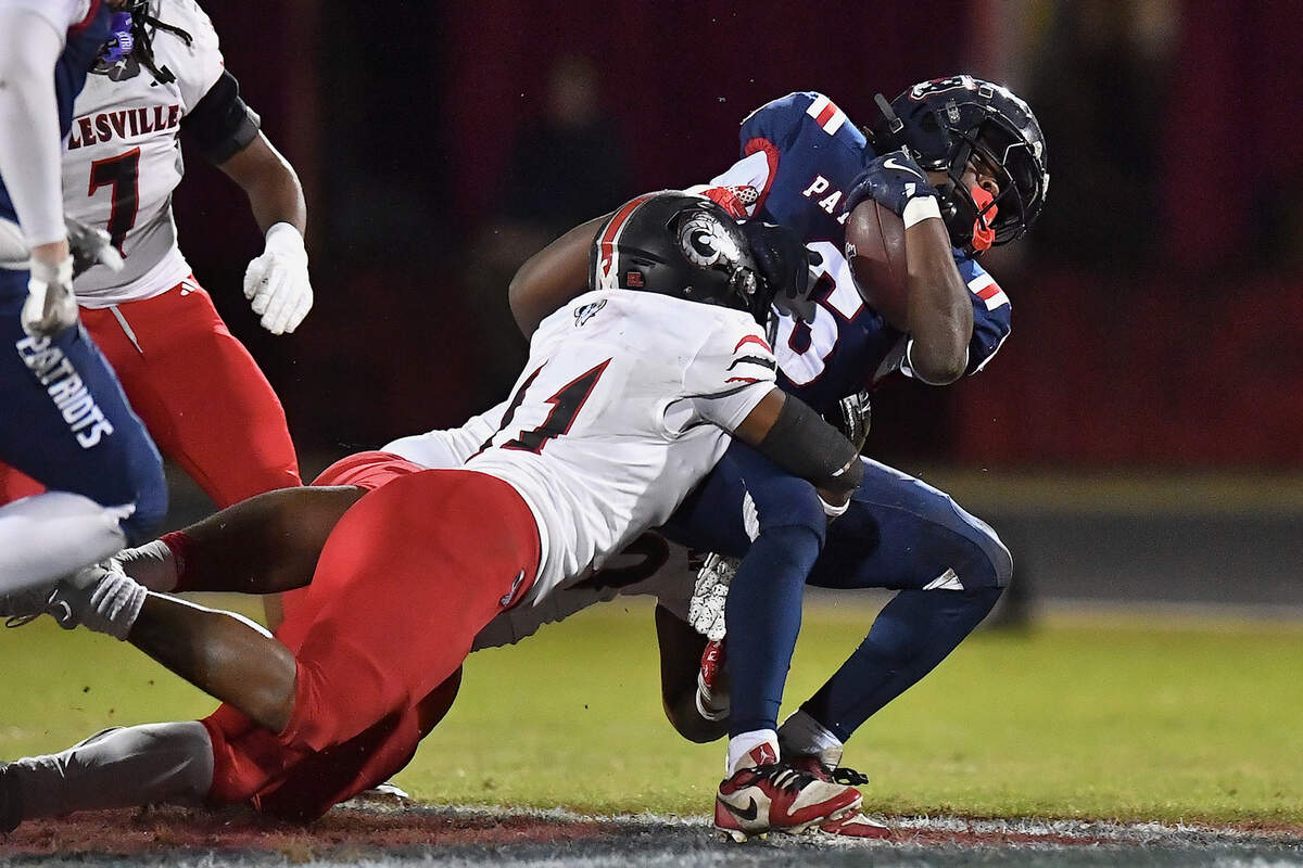 Apex Friendship running back Michael Mallard (6) is tackled by Rolesville's Javon Campbell (11) during the first half. The Apex Friendship Patriots and the Rolesville Rams met in  the second round of the  NCHSAA 8A Playoff game in Apex, N.C. on November 14, 2025. Rolesville wins 14-7 in overtime.