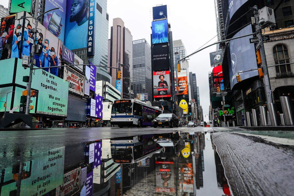 Vehicles move through a nearly empty Times Square on Saturday, May 23, 2020, in New York. (AP Photo/Frank Franklin II)