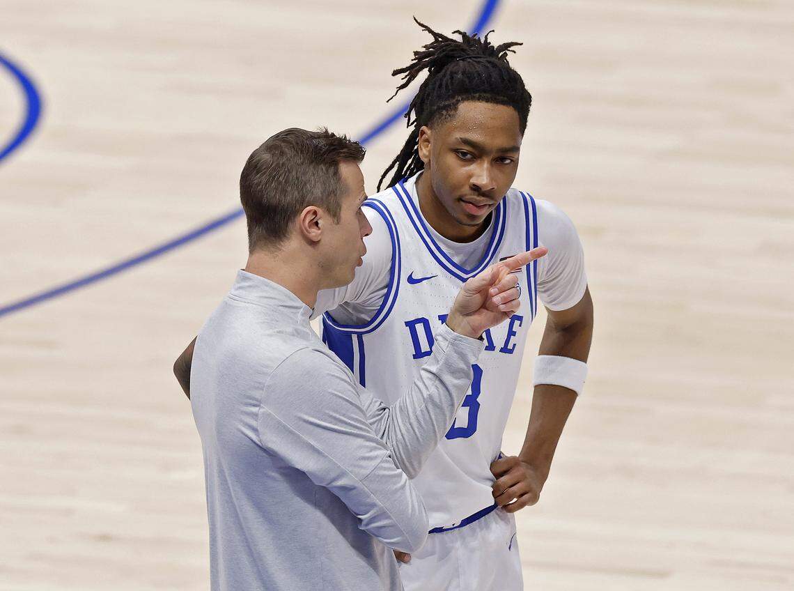 Duke head coach Jon Scheyer talks with Isaiah Evans during the first half of the Blue Devils’ ACC Tournament quarterfinal game against Florida State on Thursday, March 12, 2026, at the Spectrum Center in Charlotte, N.C. 