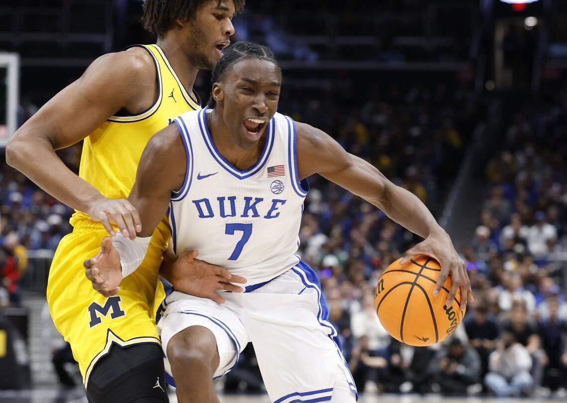 Duke’s Dame Sarr (7) drives by Michigan's Morez Johnson Jr. (21) during the first half of Duke’s game against Michigan in the Capital Showcase at Capital One Arena in Washington, D.C., Saturday, Feb. 21, 2026.