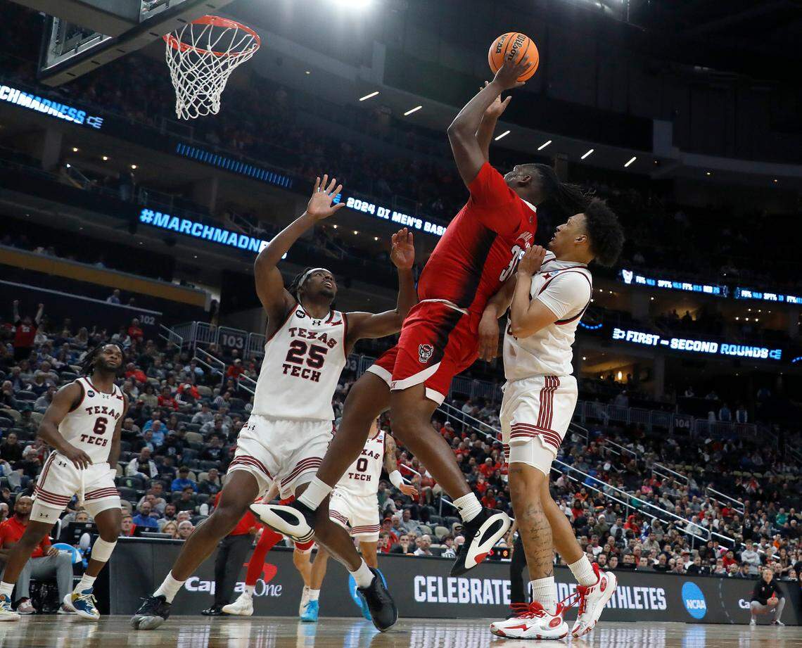N.C. State’s DJ Burns Jr. puts up a shot over Texas Tech’s Robert Jennings during the second half of the Wolfpack’s 80-67 win in the first round of the NCAA Tournament on Thursday, March 21, 2024, at PPG Paints Arena in Pittsburgh, Pa.