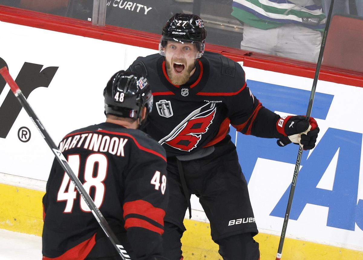 Carolina's Nikolaj Ehlers (27) celebrates with Jordan Martinook (48) after Ehlers scored in the first period of the Hurricanes’ game against the Golden Knights in the first game of the Stanley Cup Final at the Lenovo Center in Raleigh, N.C., Tuesday, June 2, 2026.