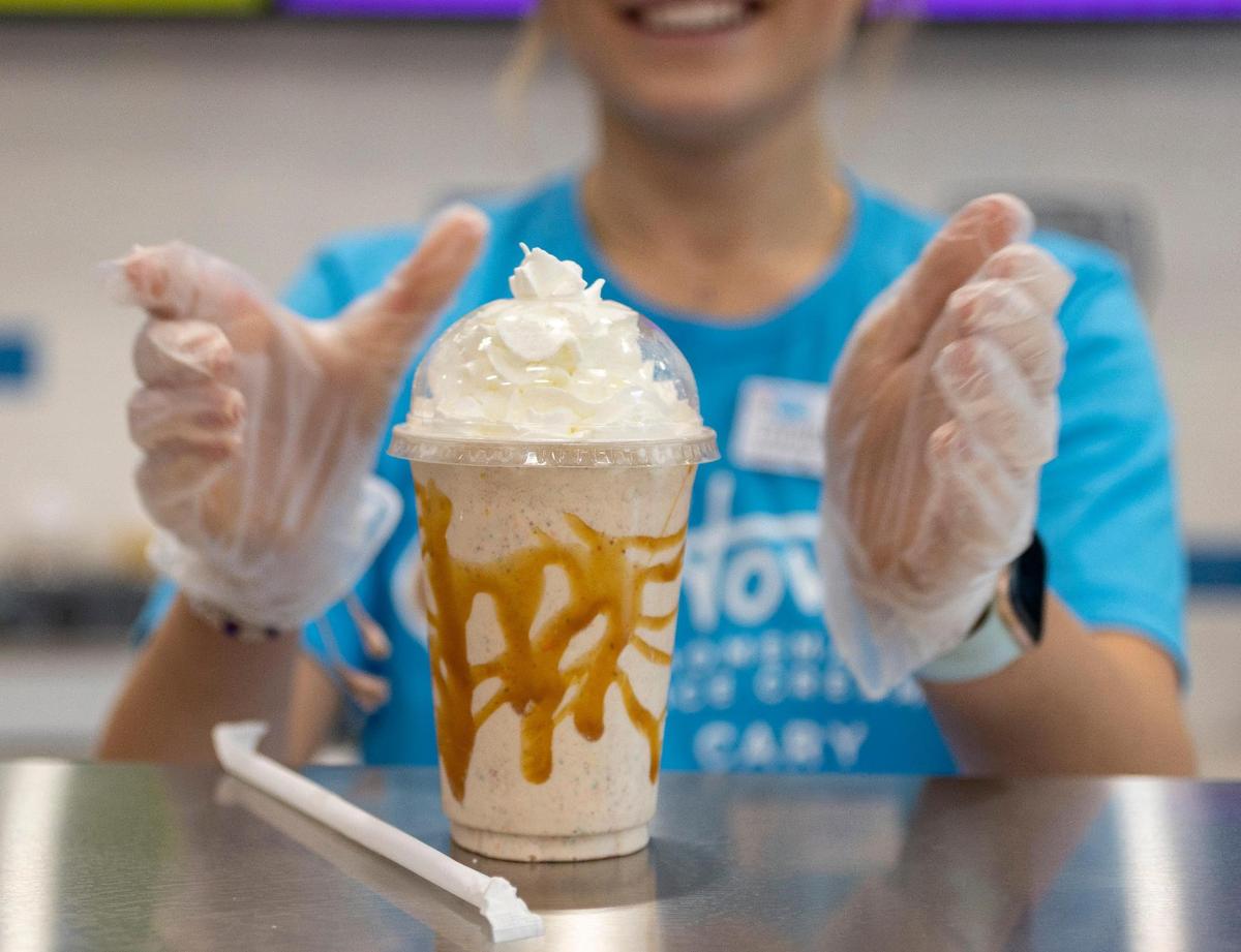Maura Timblin puts the final touches on a cinnamon bun milkshake at Howdy Ice Cream on Thursday, March 2, 2023 in Cary, N.C.