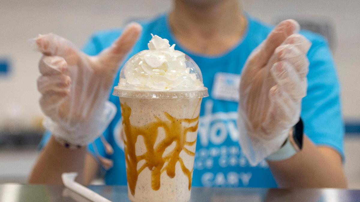 Maura Timblin puts the final touches on a cinnamon bun milkshake at Howdy Homemade Ice Cream on Thursday, March 2, 2023 in Cary, N.C.