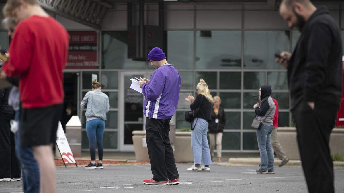 Philip Woodward, center, of Raleigh, N.C., practices social distancing with others as he waits to donate during blood drive on Thursday, March 26, 2020, at the PNC Arena in Raleigh, N.C.