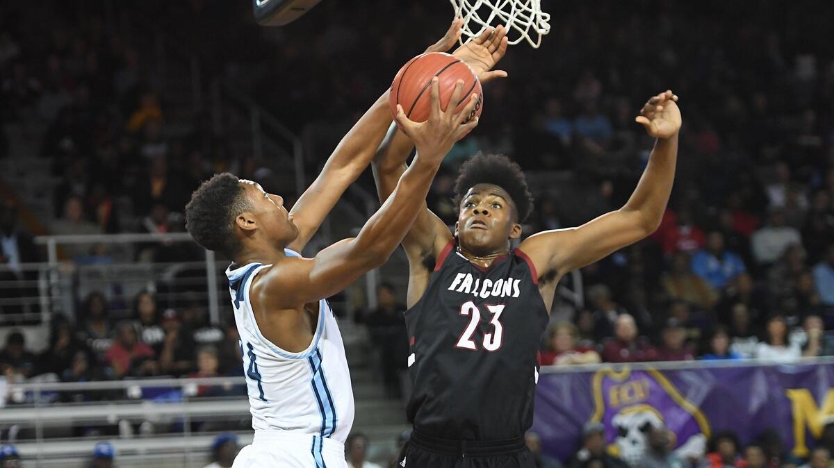 Day’ron Sharpe (23) of South Central blocks a shot from William Felton, left, of Millbrook. The Millbrook Wildcats played the South Central Falcons in a high school men basketball game on March 9, 2019.