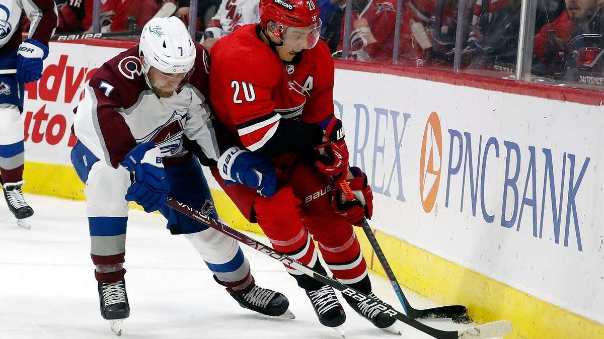 Carolina Hurricanes’ Sebastian Aho (20) guards the puck from Colorado Avalanche’s Devon Toews (7) during the second period of an NHL hockey game in Raleigh, N.C., Thursday, March 10, 2022. (AP Photo/Karl B DeBlaker)