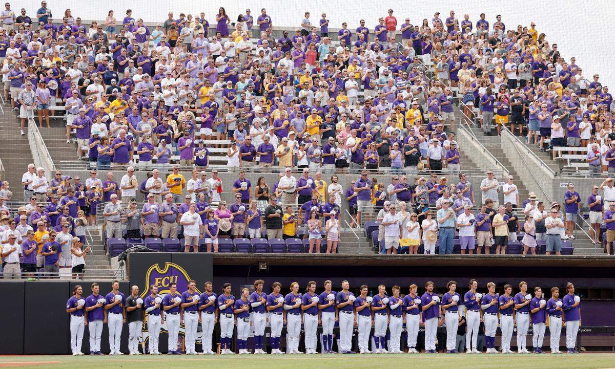 East Carolina stands during the national anthem before their game against Texas in the Greenville Super Regional at Clark-LeClair Stadium Saturday, June 11, 2022.