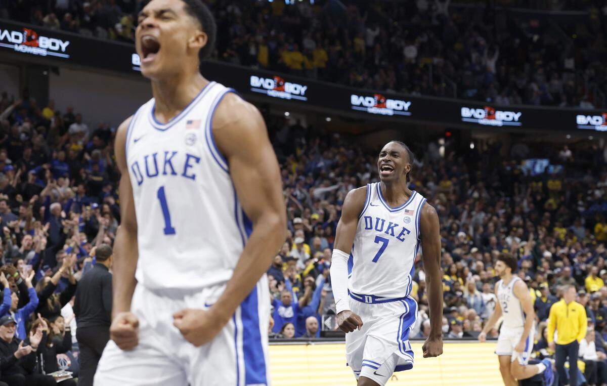 Duke’s Caleb Foster (1) and Dame Sarr (7) celebrate as time expires in Duke’s 68-63 victory over Michigan in the Capital Showcase at Capital One Arena in Washington, D.C., Saturday, Feb. 21, 2026.