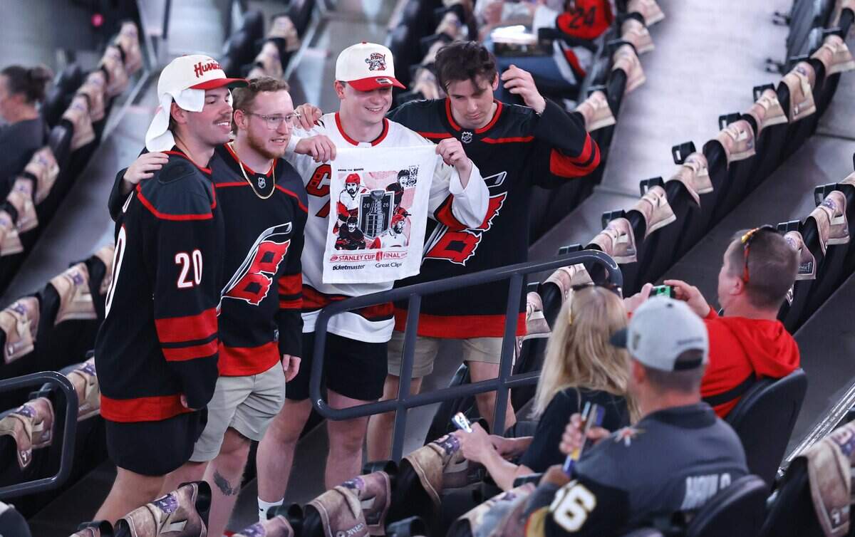 Canes fans pose with their towel before the Hurricanes’ game against the Golden Knights in Game 6 of the Stanley Cup Final at T-Mobile Arena in Las Vegas, Nev., Sunday, June 14, 2026.