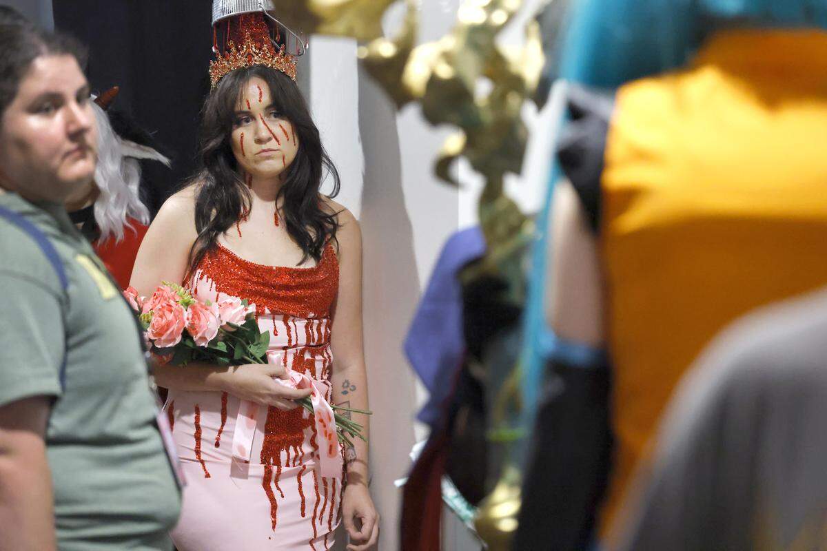 Samantha Gault of Charlotte, dressed as Carrie, waits to participate in the costume contest during GalaxyCon Raleigh at the Raleigh Convention Center Saturday, July 26, 2025.