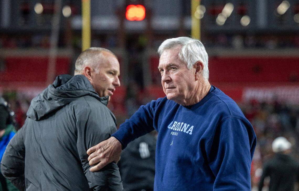 North Carolina coach Mack Brown and N.C. State coach Dave Doeren go their separate ways after a pre-game discussion prior to their game on Saturday, November 25, 2023 at Carter-Finley Stadium in Raleigh, N.C.