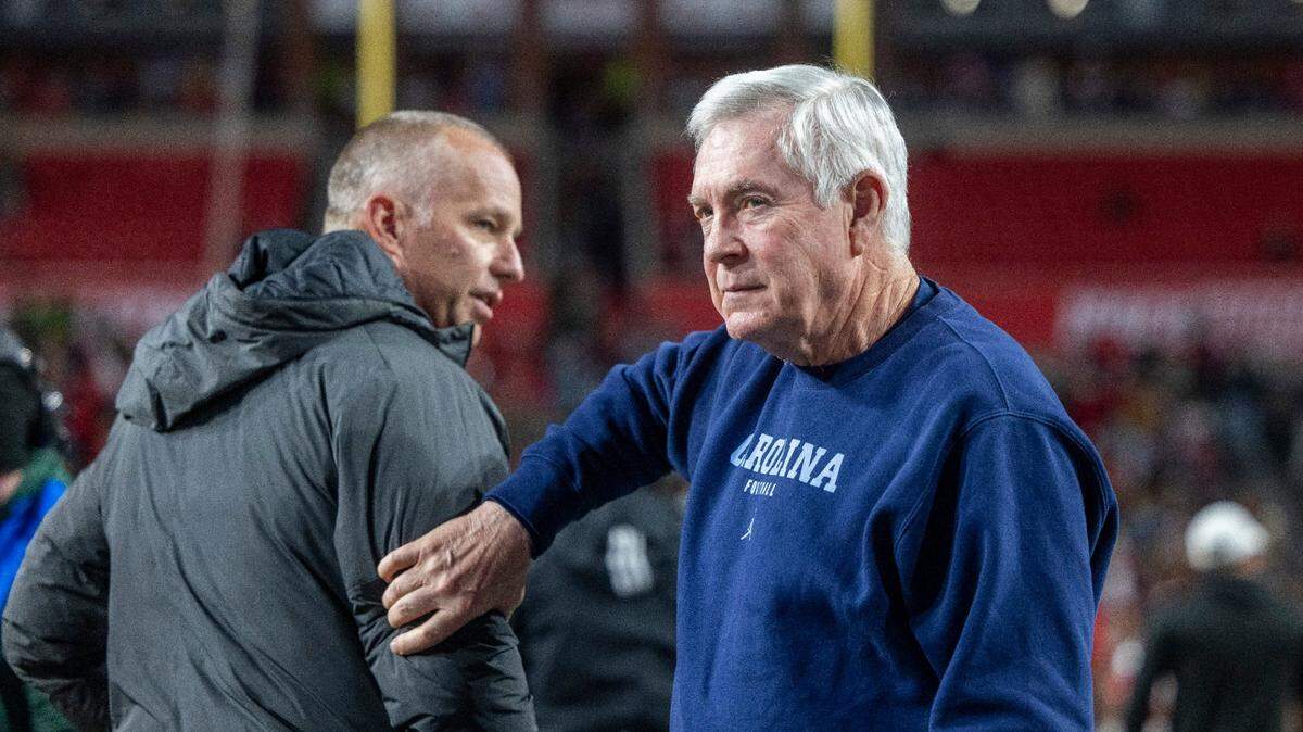 North Carolina coach Mack Brown and N.C. State coach Dave Doeren go their separate ways after a pre-game discussion prior to their game on Saturday, November 25, 2023 at Carter-Finley Stadium in Raleigh, N.C.