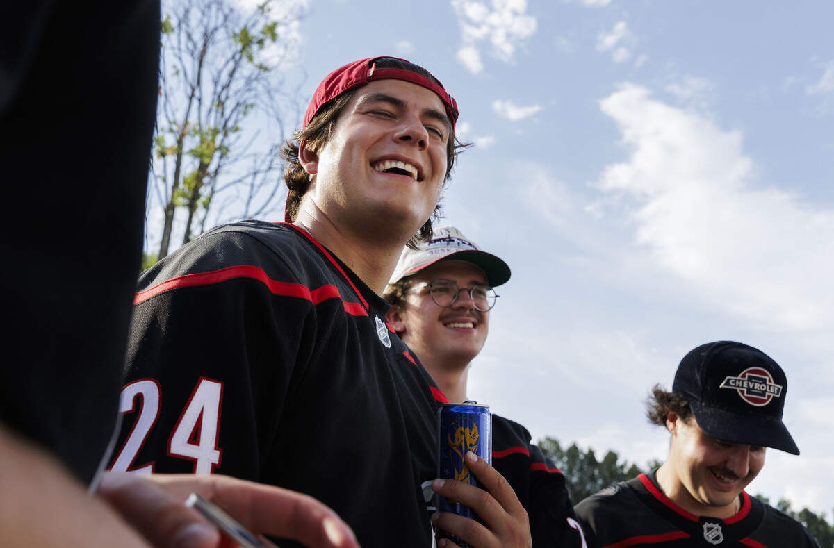 Noah Wagner laughed with his friends as they represented Carolina Hurricanes forward and group friend Seth Jarvis by sporting his #24 jersey while in the parking lot outside the Lenovo Center on June 11, 2026, in Raleigh, North Carolina. The Carolina Hurricanes take on the Las Vegas Golden Knights for Game 5 of the Stanley Cup Final.