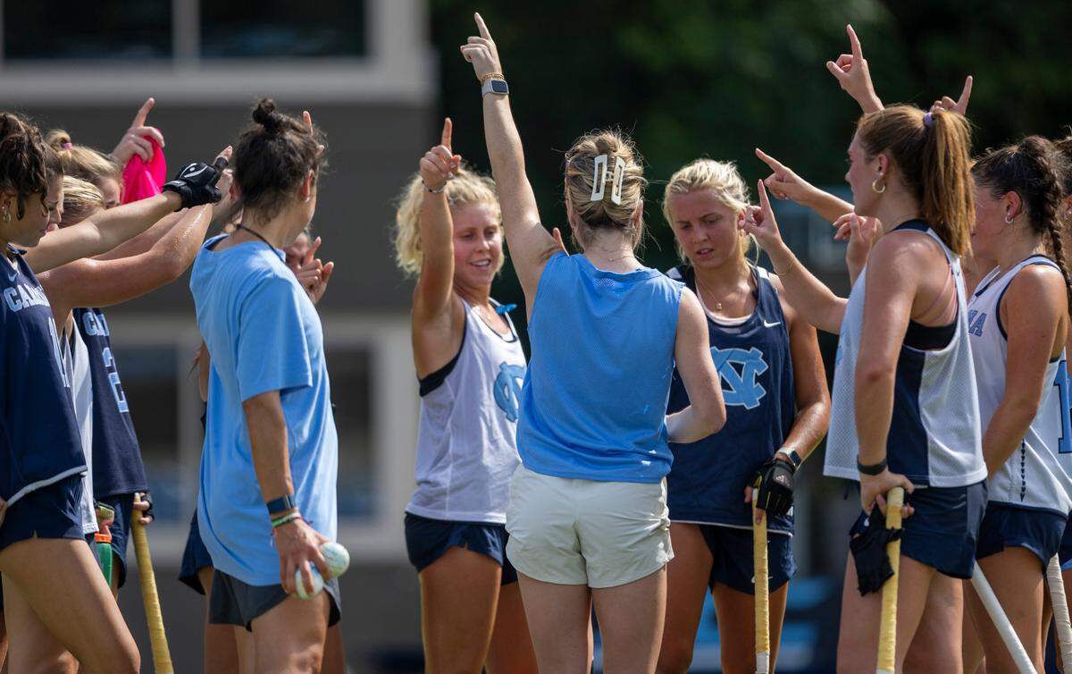 North Carolina field hockey coach Erin Matson huddles with her players during their first practice of the season on Wednesday August 9, 2023 at Karen Shelton Stadium in Chapel Hill, N.C.