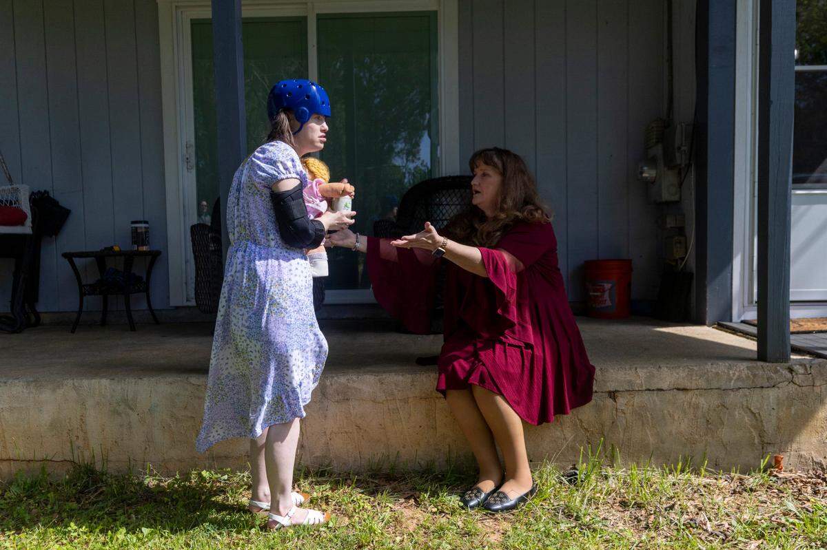 Dana Rhoney spends time with her daughter Samantha, who has a moving disorder and an intellectual disability, at their home near Claremont on Tuesday, April 23, 2024. The Rhoneys filed a lawsuit in 2017 that became known as the Samantha R. case. Disability Rights NC argued that the failure to provide access to community- and home-based behavioral health services violated the rights of people with disabilities.