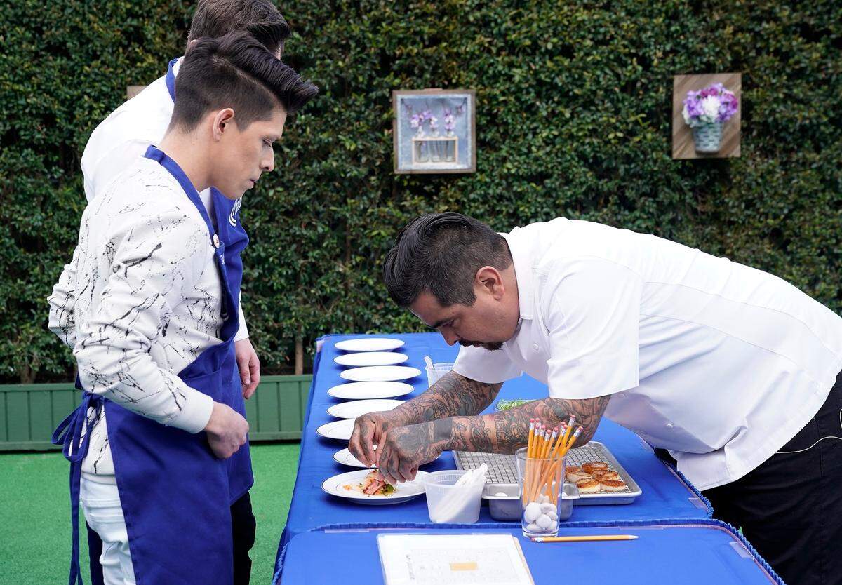Juni Cuevas, left, and judge Aarón Sánchez in the "A Gordon Ramsay Wedding" episode of "MasterChef" airing Wednesday, July 11 on Fox.