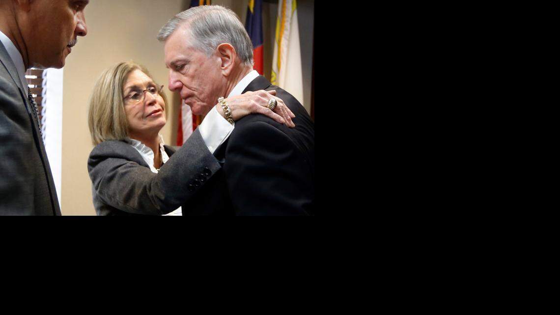 As N.C. A&T State University Chancellor Harold Martin Sr. waits, Joan G. MacNeill, member of the Board of Governors, gives UNC system President Tom Ross a hug after Ross’ departure was announced by the board during a meeting Friday at UNC-Chapel Hill.
