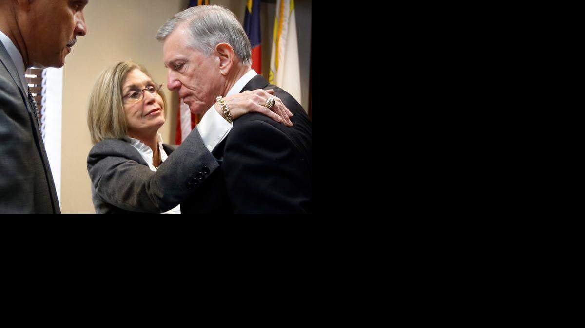 As N.C. A&T State University Chancellor Harold Martin Sr. waits, Joan G. MacNeill, member of the Board of Governors, gives UNC system President Tom Ross a hug after Ross’ departure was announced by the board during a meeting Friday at UNC-Chapel Hill.
