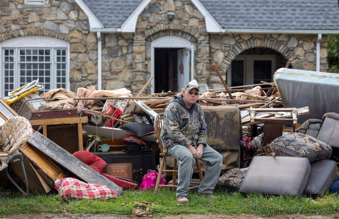 David Matteson and his wife lost all of their household belongings after historic flooding of the Pigeon River in the wake of Hurricane Helene almost three weeks ago. Matteson poses for a portrait on the curb of his Broad Street home in Clyde, N.C., on Wednesday, October 16, 2024. Volunteers have helped him remove the mud and rip out the drywall to begin the rebuilding process.