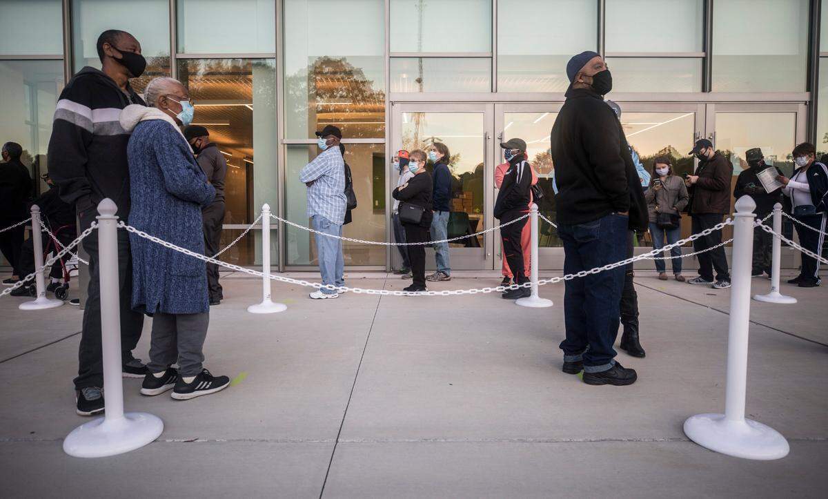 Durham County voters wait to cast their votes at the Durham County Main Library in Durham, N.C. on Thursday morning, Oct. 15, 2020, the first day of early voting.