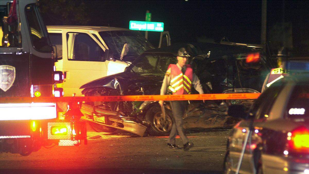 Emergency personel work the scene of a wreck where six people were killed Saturday evening, Nov. 1, 2003 at the intersection of Chapel Hill Road and Nowell Road.