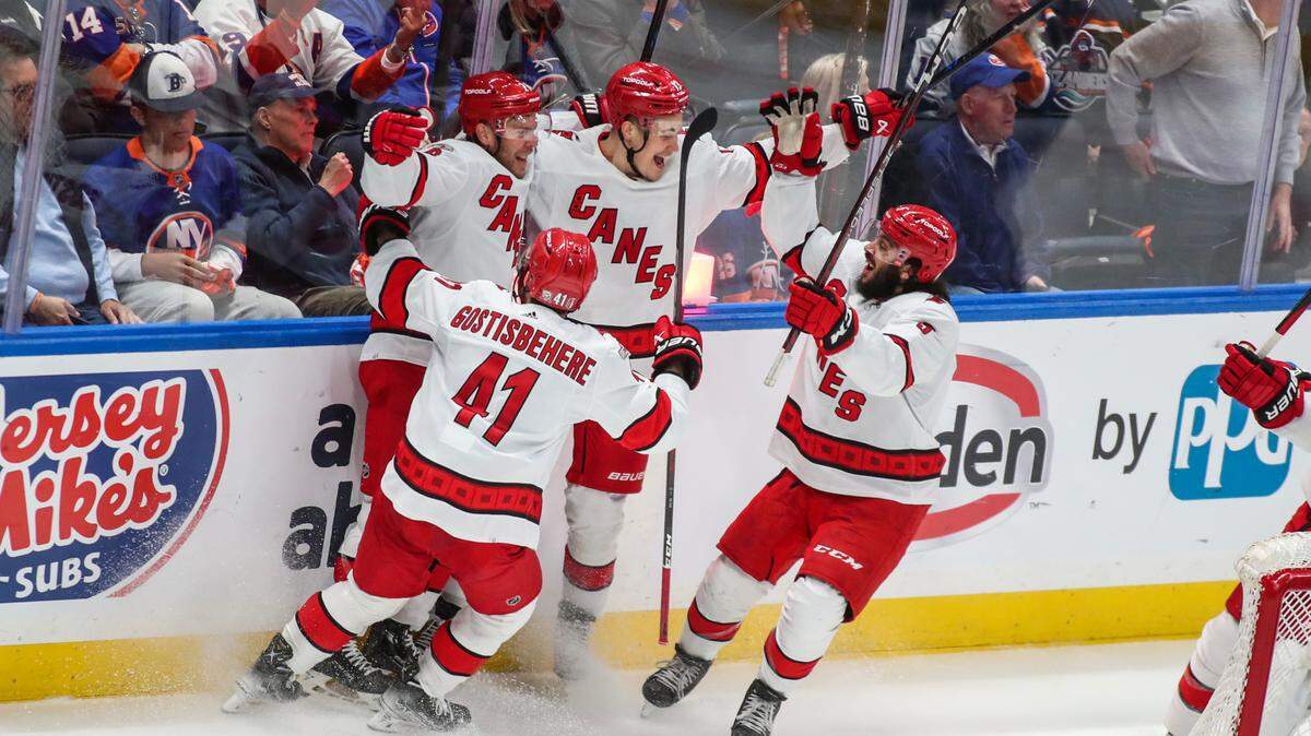 The Carolina Hurricanes celebrates after defeating the New York Islanders 2-1 in game six of the first round of the 2023 Stanley Cup Playoffs at UBS Arena.