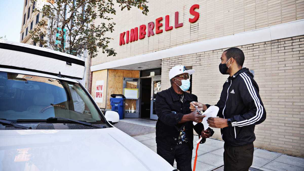 Harold McKnight, left, signs for his new king-size mattress Sept. 21, 2020 at KimbrellÕs Home Furnishings in downtown Raleigh. The family-owned business is closing its downtown Raleigh location after more than 70 years there.