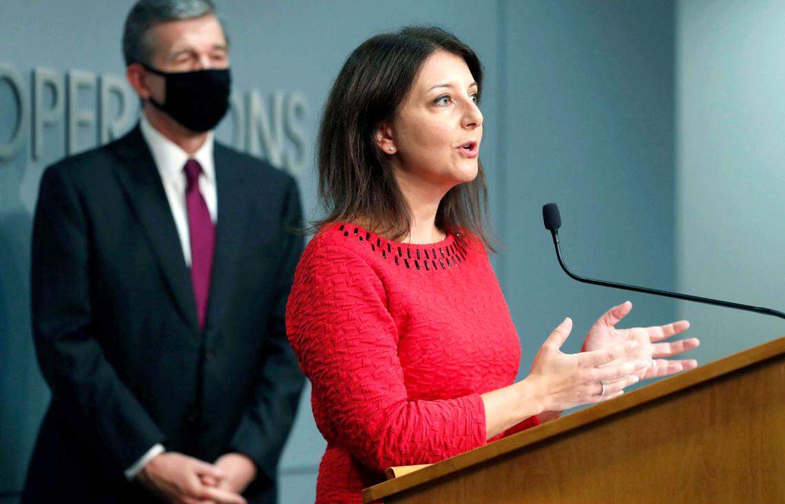 Dr. Mandy Cohen, secretary of the N.C. Department of Health and Human Services, answers a question during a briefing at the Emergency Operations Center in Raleigh, N.C., Wednesday, Oct. 28, 2020. Gov. Roy Cooper stands to the left.