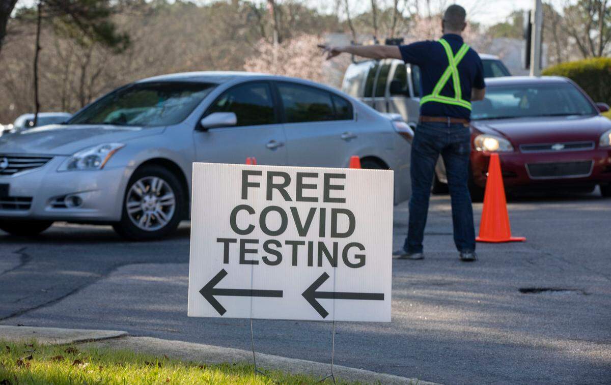 Staff at the Wake County COVID-19 testing site on Departure Drive direct clients into park spots to administer the tests on Tuesday, December 28, 2021 in Raleigh, N.C. The rapid spread of the omicron variant combined with the Christmas Holiday, has increased the demand for testing.