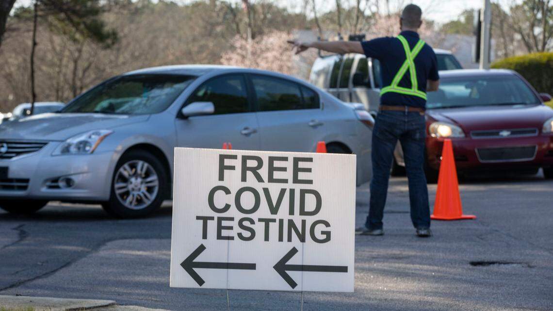 Staff at the Wake County COVID-19 testing site on Departure Drive direct clients into park spots to administer the tests on Tuesday, December 28, 2021 in Raleigh, N.C. The rapid spread of the omicron variant combined with the Christmas Holiday, has increased the demand for testing.