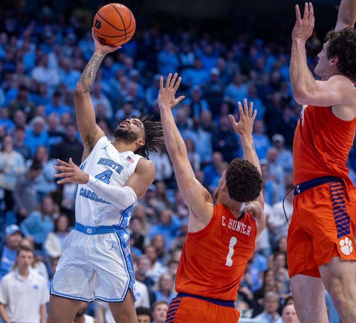 North Carolina’s R.J. Davis (4) drives to the basket against Clemson’s Chase Hunter (1) and P.J. Hall (24) in the second half on Tuesday, February 6, 2024 at the Dean E. Smith Center in Chapel Hill, N.C.