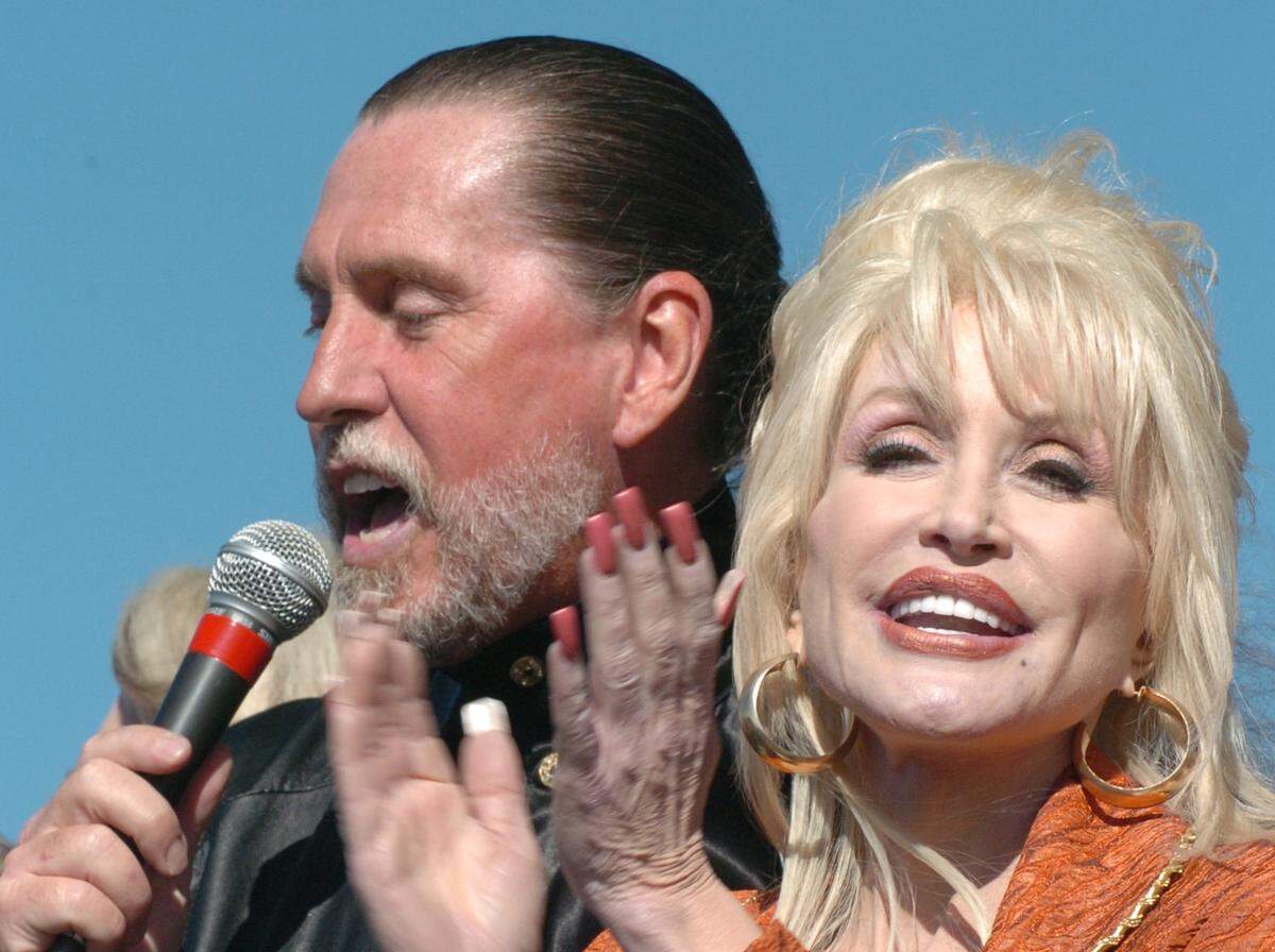 Randy Parton and his sister Dolly Parton sing the Star Spangled Banner in front of several thousand attendees of the groundbreaking ceremony for the Randy Parton Theatre and Carolina Crossroads Music & Entertainment District Friday Nov.11, 2005 in Roanoke Rapids. The estimated $129 million project is hoped to bring life into the flagging economy of Halifax County.