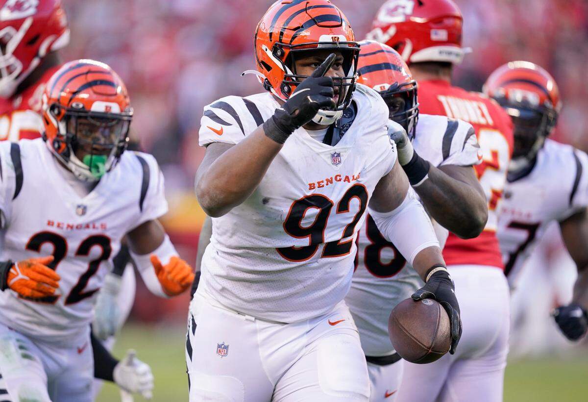 Cincinnati Bengals defensive end B.J. Hill (92) celebrates after intercepting a pass during the second half of the AFC championship NFL football game against the Kansas City Chiefs, Sunday, Jan. 30, 2022, in Kansas City, Mo. (AP Photo/Ed Zurga)