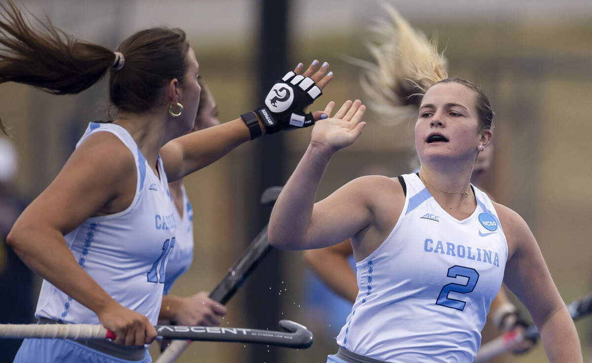North Carolina forward Charly Bruder (2) congratulates teammate Dani Mendez (10) after a Mendez assist on a goal in the first quarter against Northwestern in the national semi-final game on Friday, November 21, 2025 in Durham, N.C.