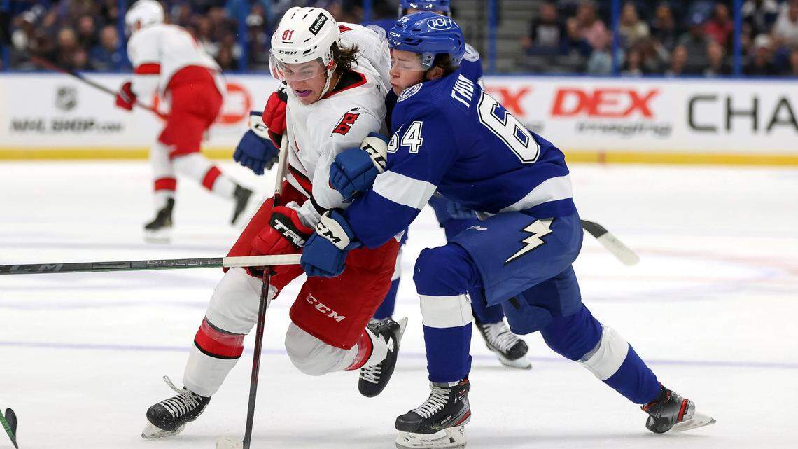 Carolina Hurricanes’ Jamieson Rees fights through the check of Tampa Bay Lightning’s Jack Thompson during the first period of a preseason NHL hockey game Friday, Oct. 1, 2021, in Tampa, Fla. (AP Photo/Mike Carlson)