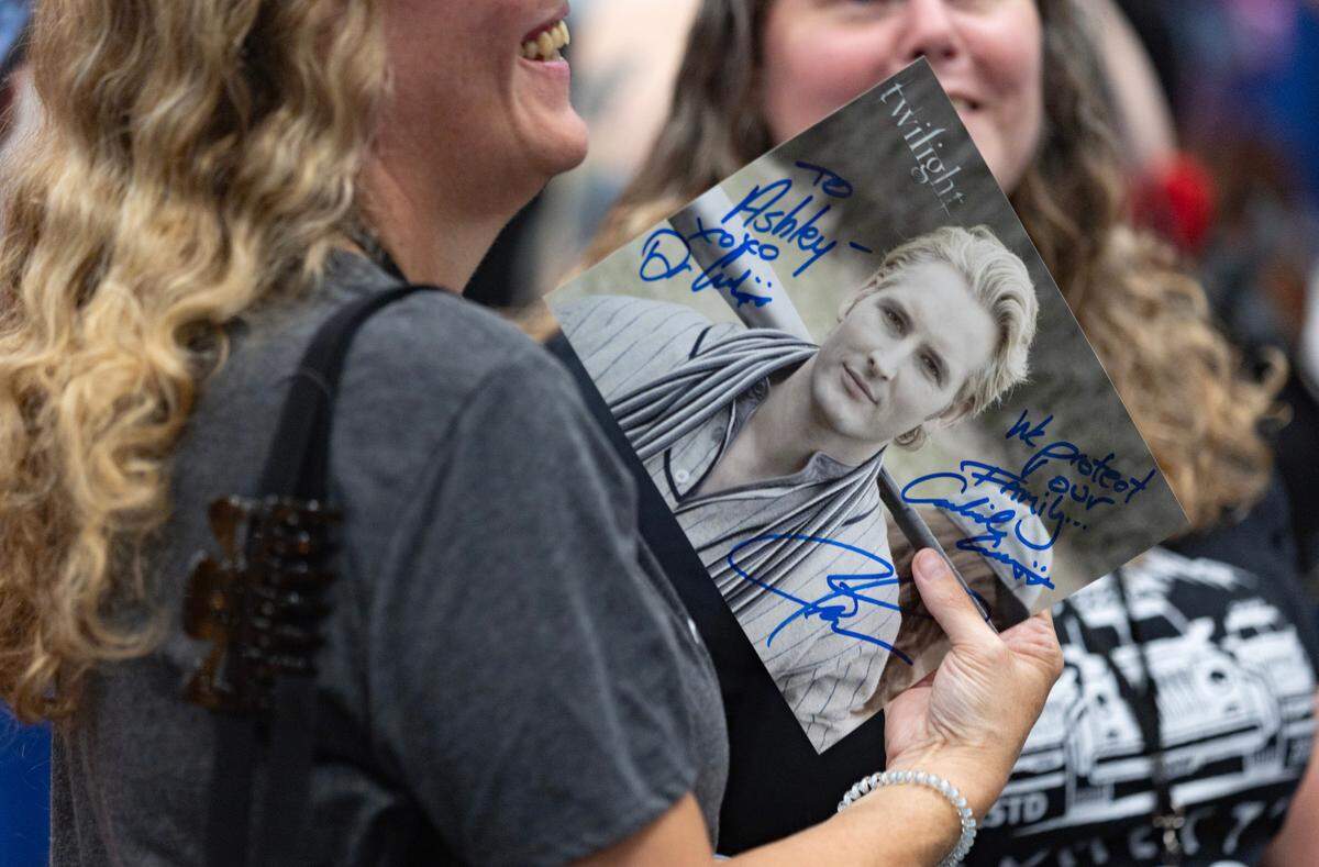 A Twilight fan holds a signed Peter Facinelli picture at Galaxycon in the Raleigh, N.C. Convention Center on Friday, July 25, 2025.